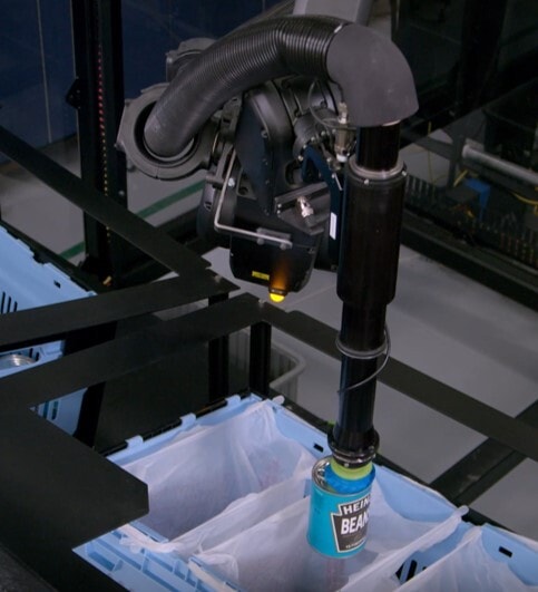 The SpectrumGripper places a can of beans in a grocery bag
