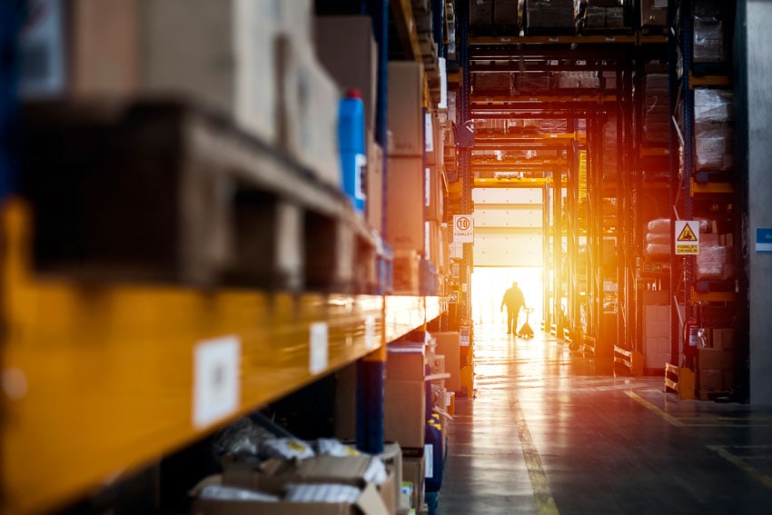 Warehouse interior with worker at sunset
