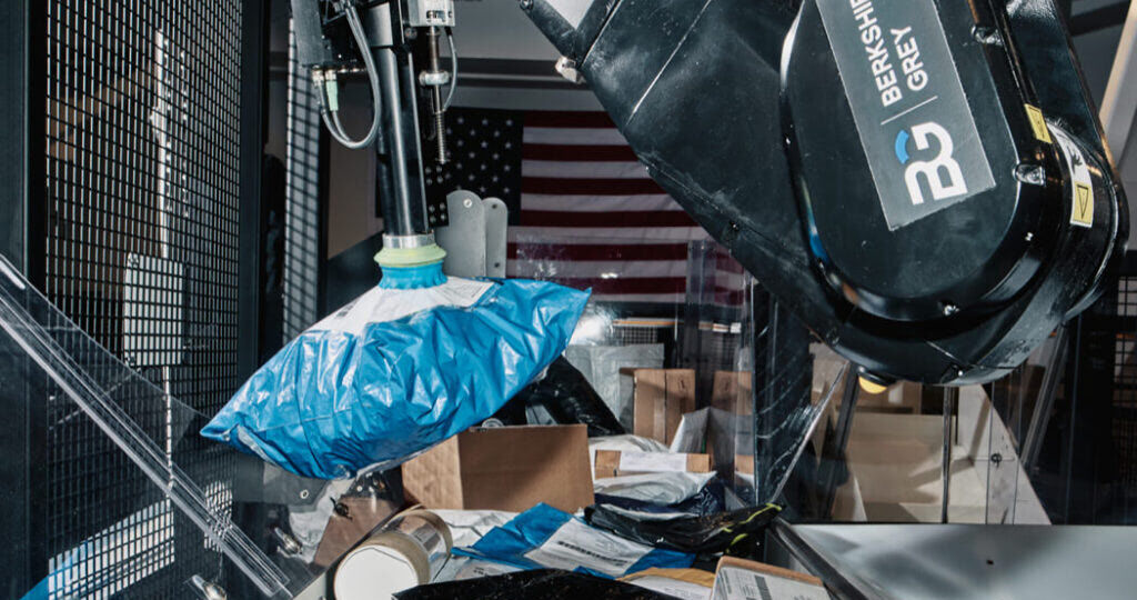 Berkshire Grey sortation robot grips and identifies a stream of mixed packages