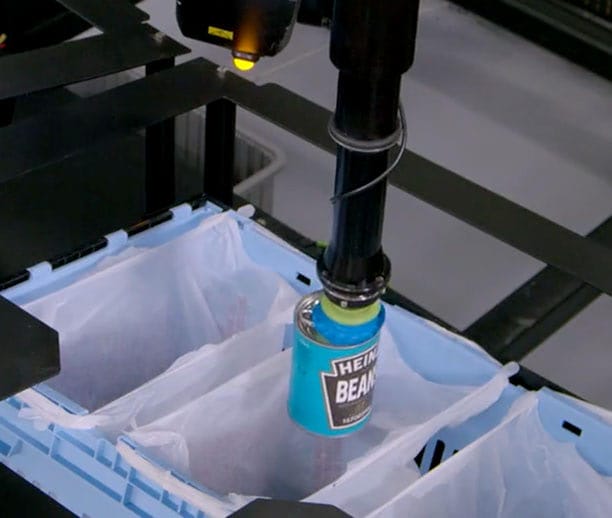 BG SpectrumGripper carefully places canned goods into a grocery bag.