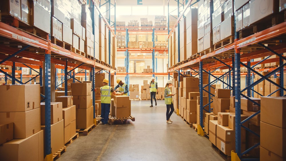 Warehouse workers sort boxes of retail goods