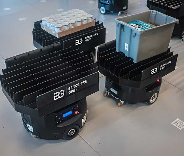 Berkshire Grey mobile robots transfer goods in low-density storage.