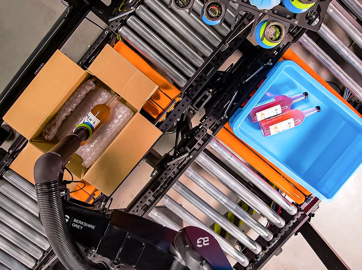 Berkshire Grey Robotic Pick and Pack (BG RPP) solution carefully places wine bottles in a box for online order fulfillment