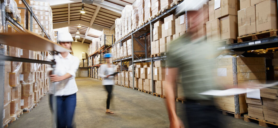 Warehouse personnel move through the facility