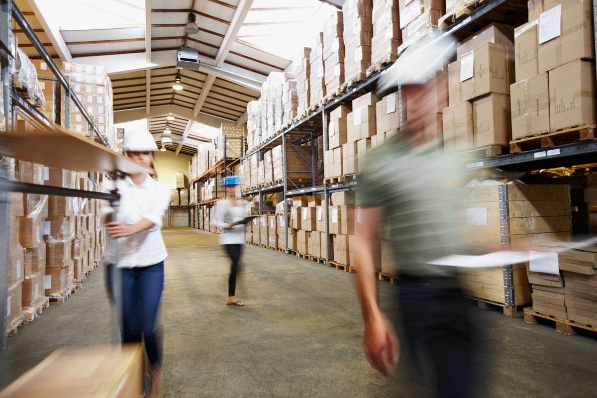 Warehouse personnel move through the facility