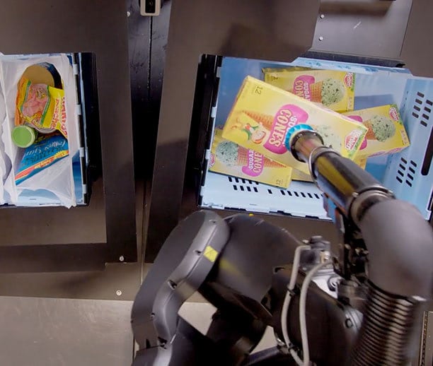 A Berkshire Grey pick and pack station fulfills the most demanding of orders... ice cream cones from an inventory tote into bags by rotating the long dimension box to place through a narrow opening.