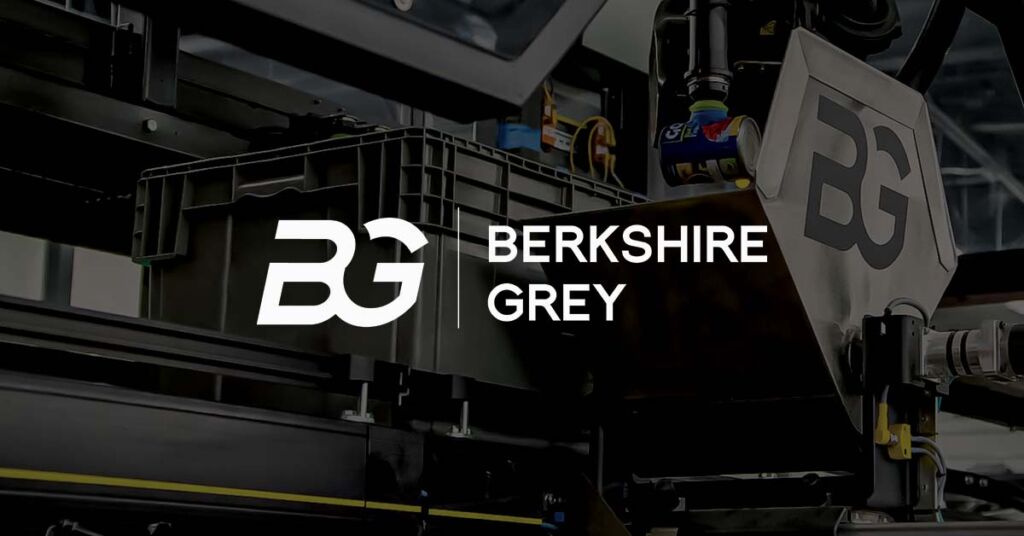 Berkshire Grey title slide with logo and robotic picking arm and shuttle in the background