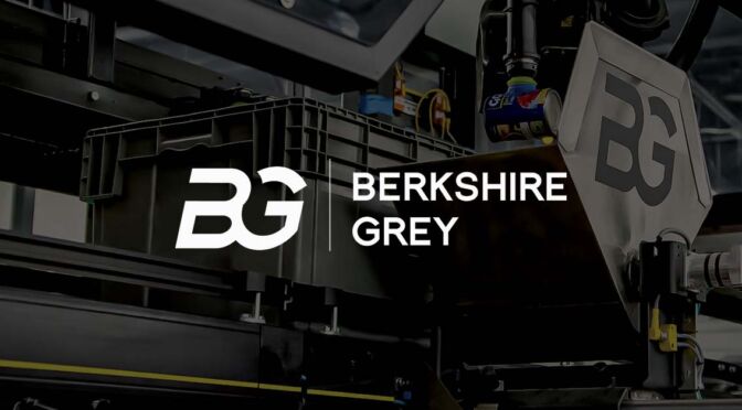 Berkshire Grey title slide with logo and robotic picking arm and shuttle in the background