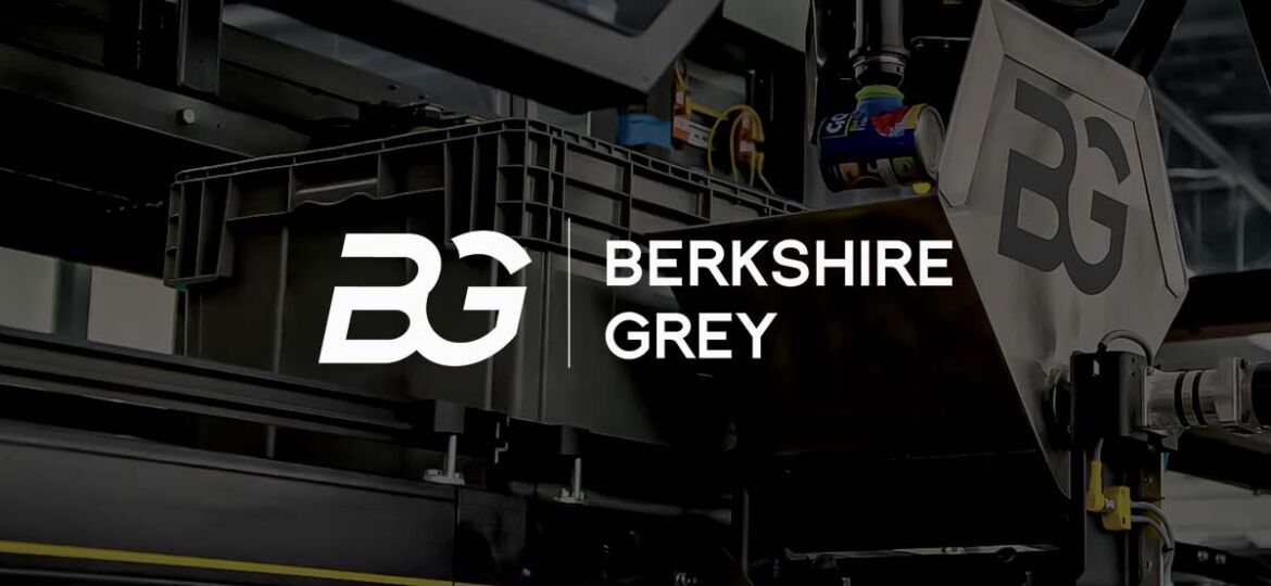 Berkshire Grey title slide with logo and robotic picking arm and shuttle in the background