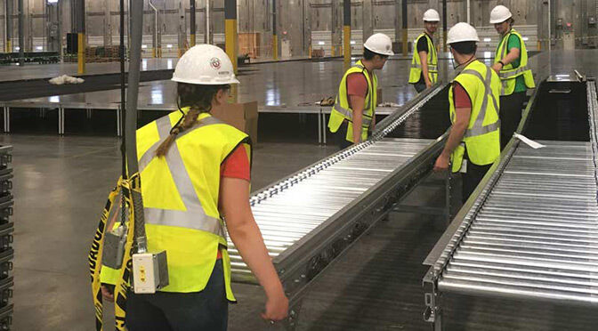 Warehouse workers install equipment