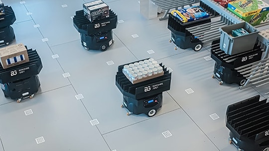 BG Mobile FLEXbots transfer SKUs to low-density storage for aisle-ready sortation into totes
