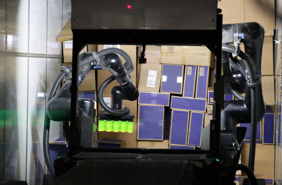 Scoop™ Trailer Unloader unloading a trailer of varied boxes