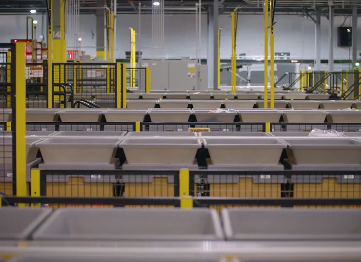 Rows of automated storage bins and sorting racks in a warehouse facility.