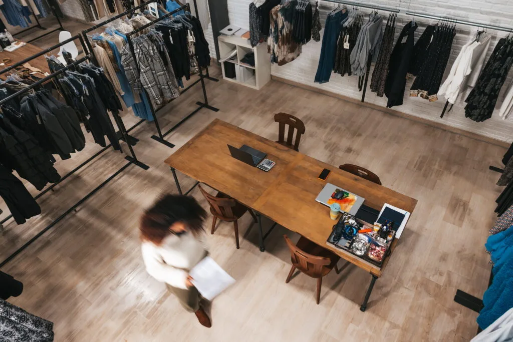 High-angle view of a boutique retail store layout with clothing racks.